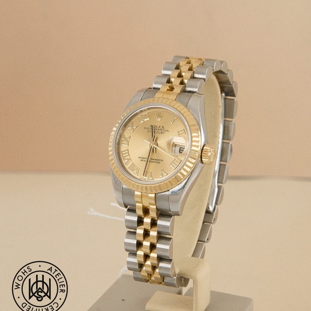 Two-tone Rolex Datejust watch on a display stand, gold dial with Roman numerals and date window, fluted bezel and two-tone bracelet DSC02967