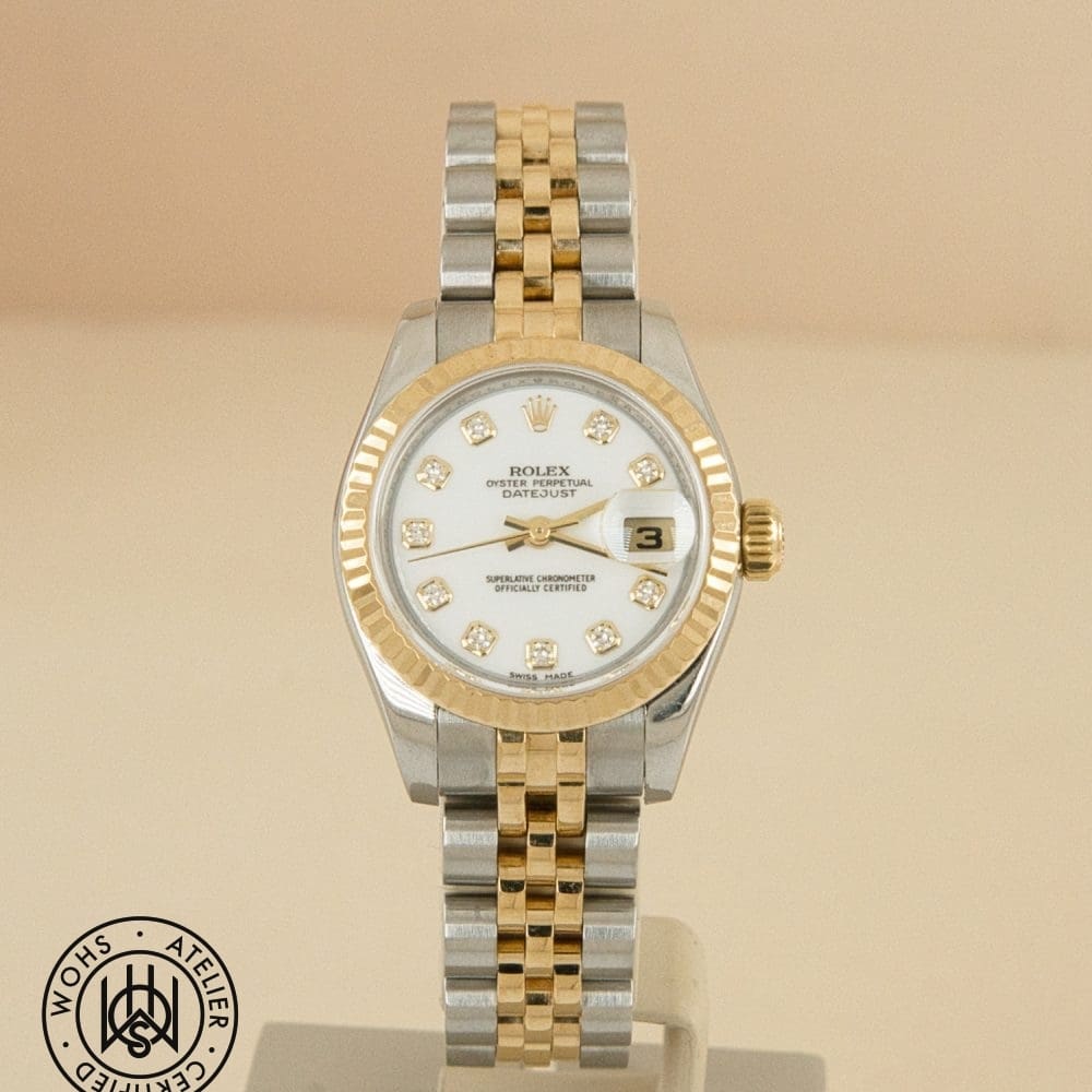 Two-tone Rolex Datejust wristwatch with diamond hour markers and a date window on display.