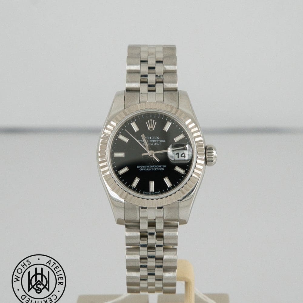 Rolex Datejust stainless steel wristwatch with a black dial, fluted bezel, and a magnified date window at 3 o'clock showing the number 14.