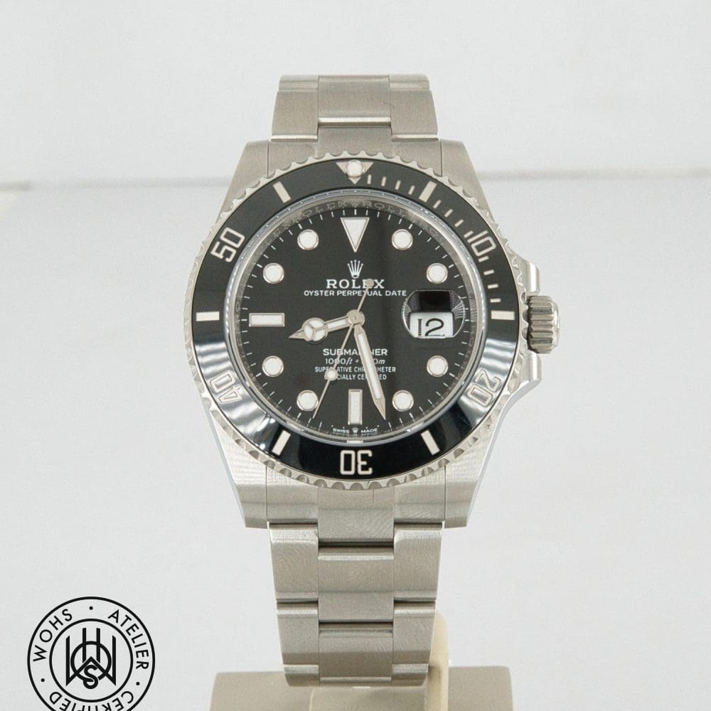 Rolex Oyster Perpetual Date Submariner stainless steel watch on a display stand with black dial and rotating bezel