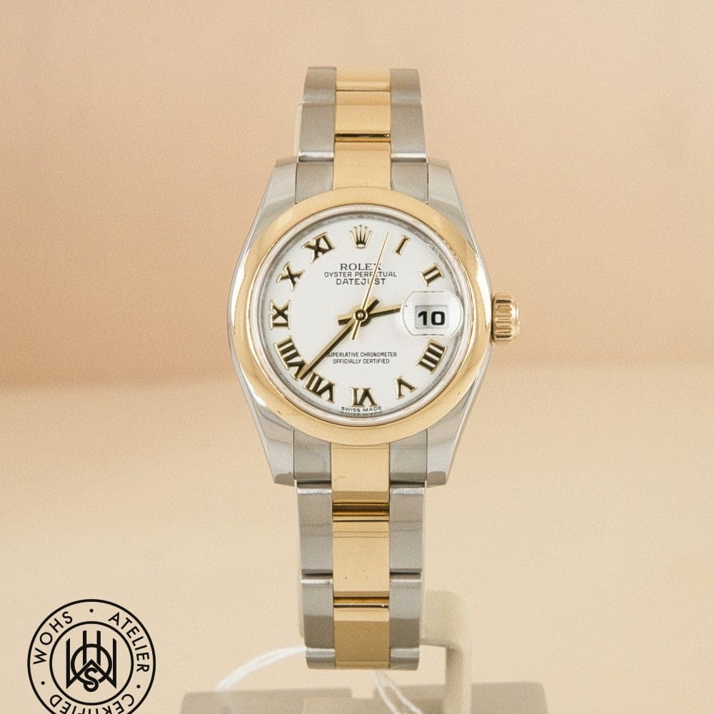 Two-tone Rolex Datejust wristwatch with gold bezel and silver-gold bracelet, white dial, Roman numerals, and a date window.