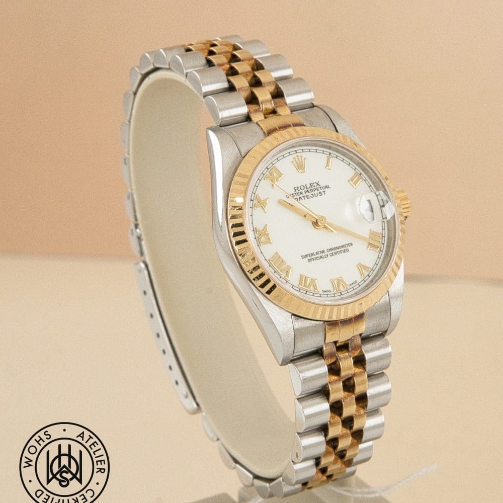 Two-tone Rolex wristwatch with gold and silver bracelet, white dial, Roman numerals, and magnified date window at 3 o'clock (close-up) DSC03154