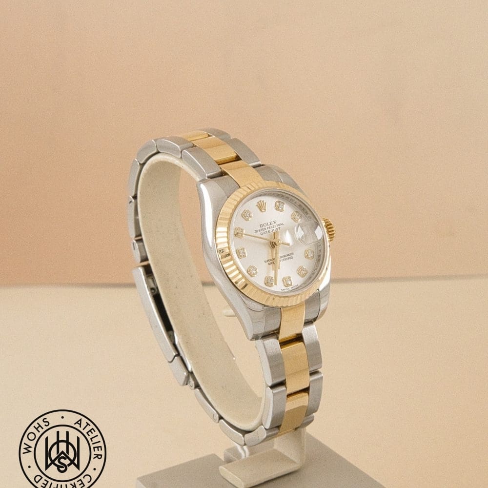 Two-tone Rolex Datejust wristwatch with gold bezel and diamond hour markers on a display stand DSC03248