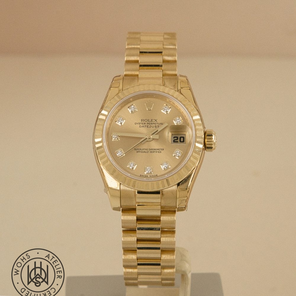 Gold Rolex Datejust wristwatch with diamond hour markers and a date window at 3 o'clock set on a display pedestal Preowned Ladies Rolex Datejust 179178 NOS unworn 1