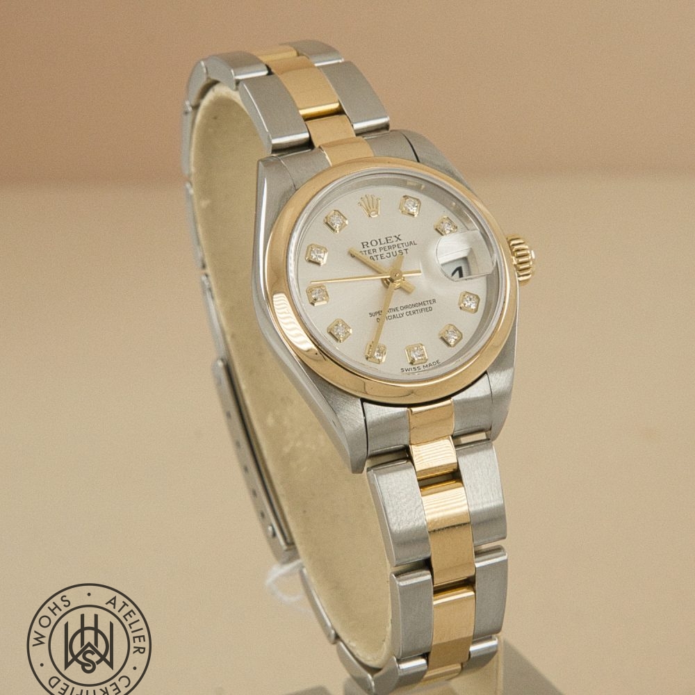 Two-tone Rolex Datejust wristwatch with diamond hour markers and a date window magnifier, silver dial, gold bezel, and stainless steel bracelet. Preowned Rolex Lady Datejust 79163 silver diamond 3