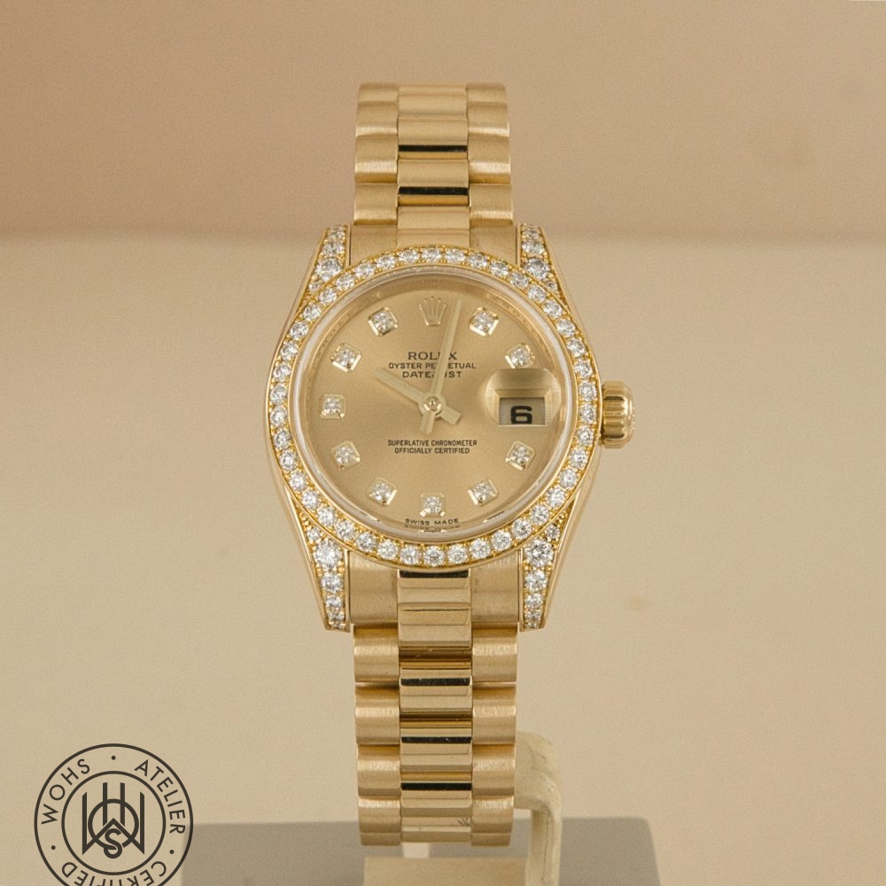 Gold Rolex Oyster Perpetual Datejust wristwatch with diamond-studded bezel on a display stand Preowned Rolex Lady Datejust reference 179158 factory set lugs and bezel 2
