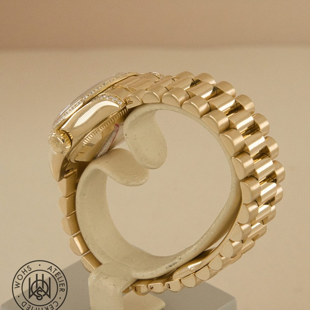 Close-up of a gold wristwatch on a display stand, showing the crown and diamond-studded bezel from the side. Preowned Rolex Lady Datejust reference 179158 factory set lugs and bezel 6