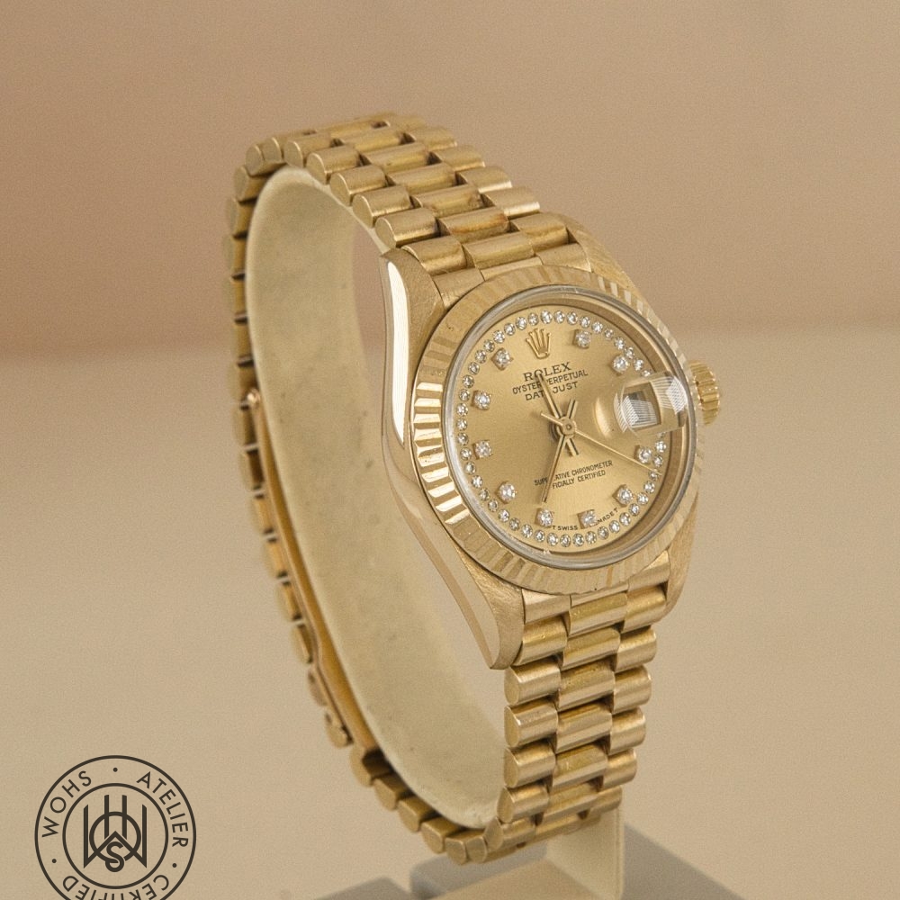 Gold Rolex Datejust watch with a diamond-encrusted dial and fluted bezel on display, angled view. Rolex Ladies Datejust 26mm 69178 Diamond Hour and Pave set markers 18ct dial 3