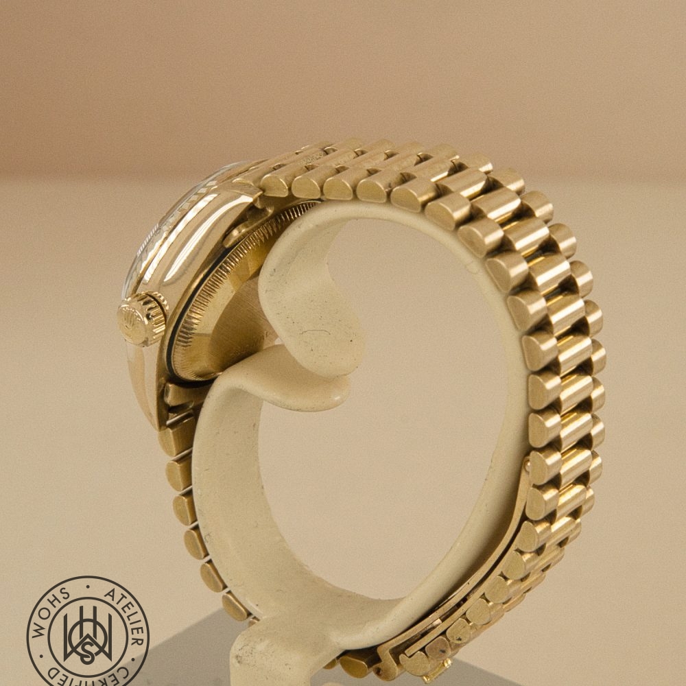 Side view of a gold-toned wristwatch with a multi-link bracelet and visible crown on the left side. Rolex Ladies Datejust 26mm 69178 Diamond Hour and Pave set markers 18ct dial 5