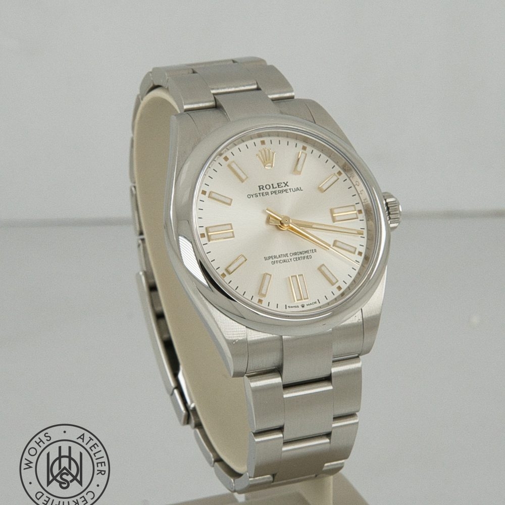 Silver Rolex Oyster Perpetual wristwatch with cream dial and gold hour markers on a stainless steel bracelet. Rolex Oyster Perpetual Pre-Owned reference 134300 41mm silver dial box papers 2025 3