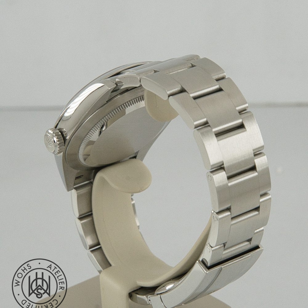 Close-up of a stainless steel wristwatch from the side, highlighting the crown and thick metal bracelet Rolex Oyster Perpetual Pre-Owned reference 134300 41mm silver dial box papers 2025 6