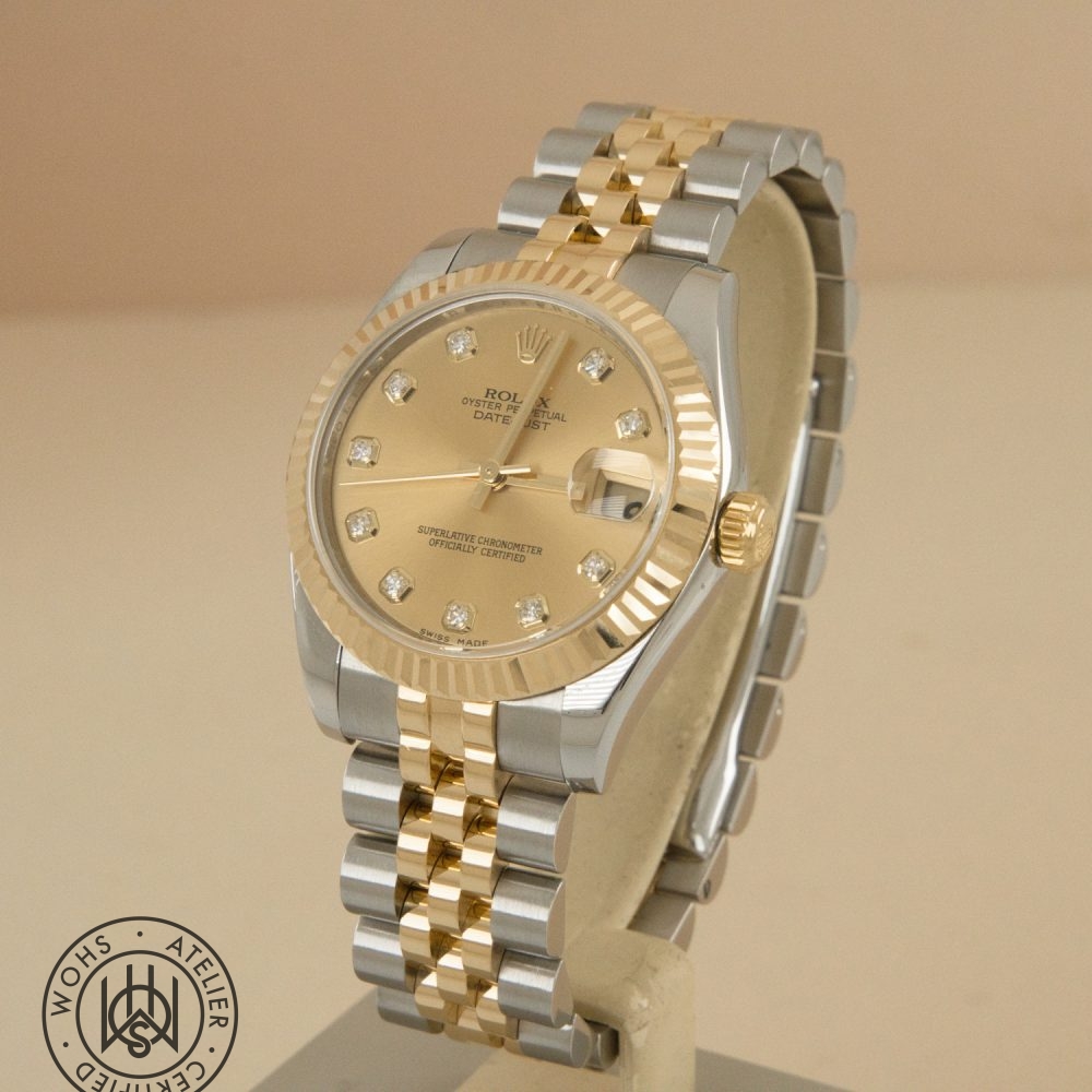 Two-tone Rolex Datejust watch with a gold fluted bezel, champagne dial, diamond hour markers, and stainless steel bracelet on a display stand. Used Ladies Rolex datejust reference 178273 champange diamond dial 1