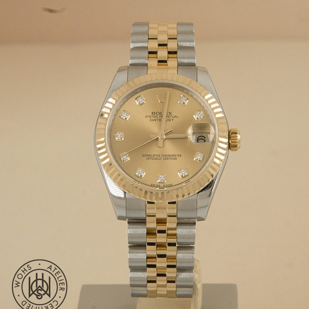 Used Ladies Rolex datejust reference 178273 champange diamond dial 2 - Watches Of Henley St Two-tone Rolex Datejust watch with a gold bezel, diamond hour markers, and two-tone bracelet on a beige background. Used Ladies Rolex datejust reference 178273 champange diamond dial 2