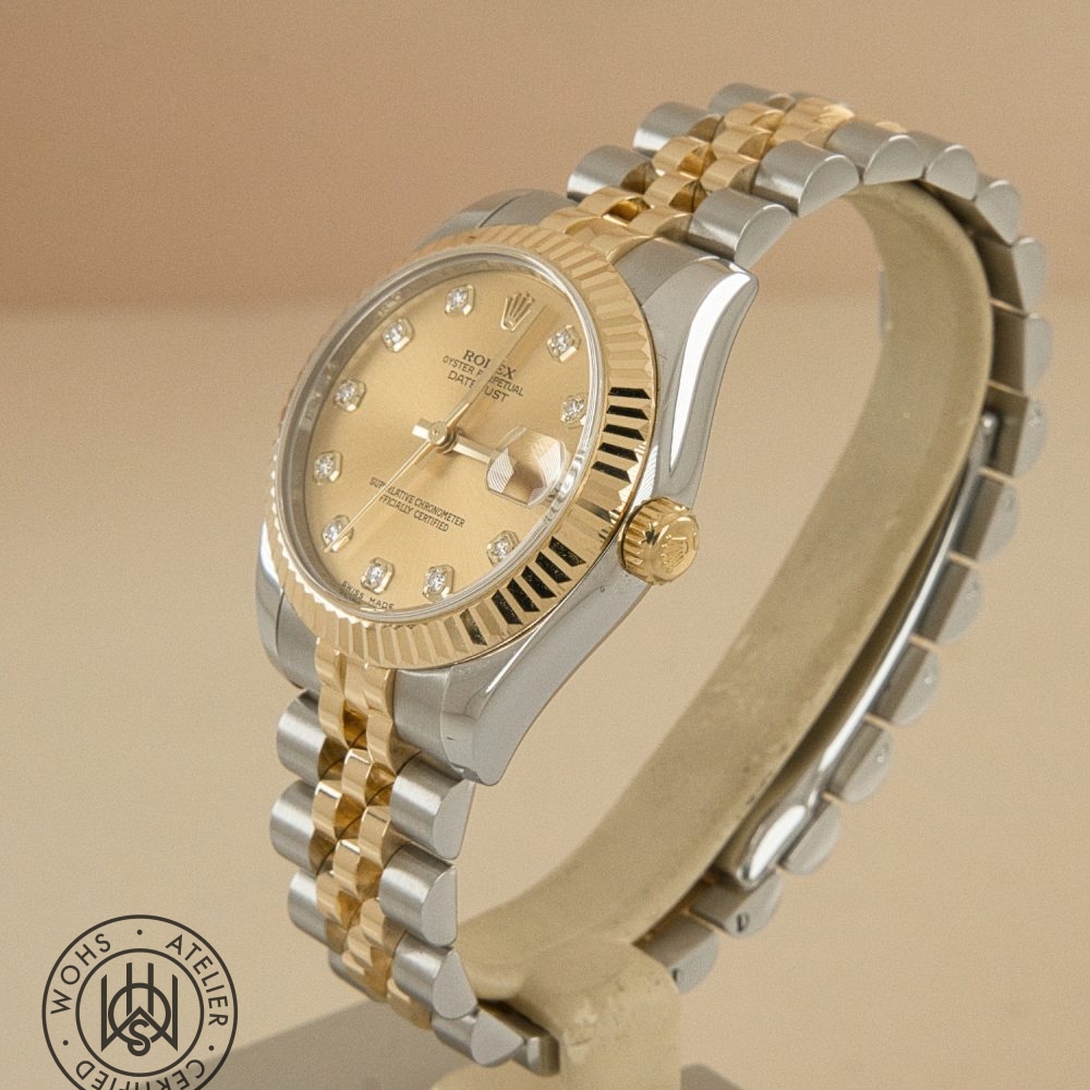 Two-tone Rolex Datejust watch with gold bezel, diamond hour markers, and a Jubilee bracelet on a display stand. Used Ladies Rolex datejust reference 178273 champange diamond dial 7